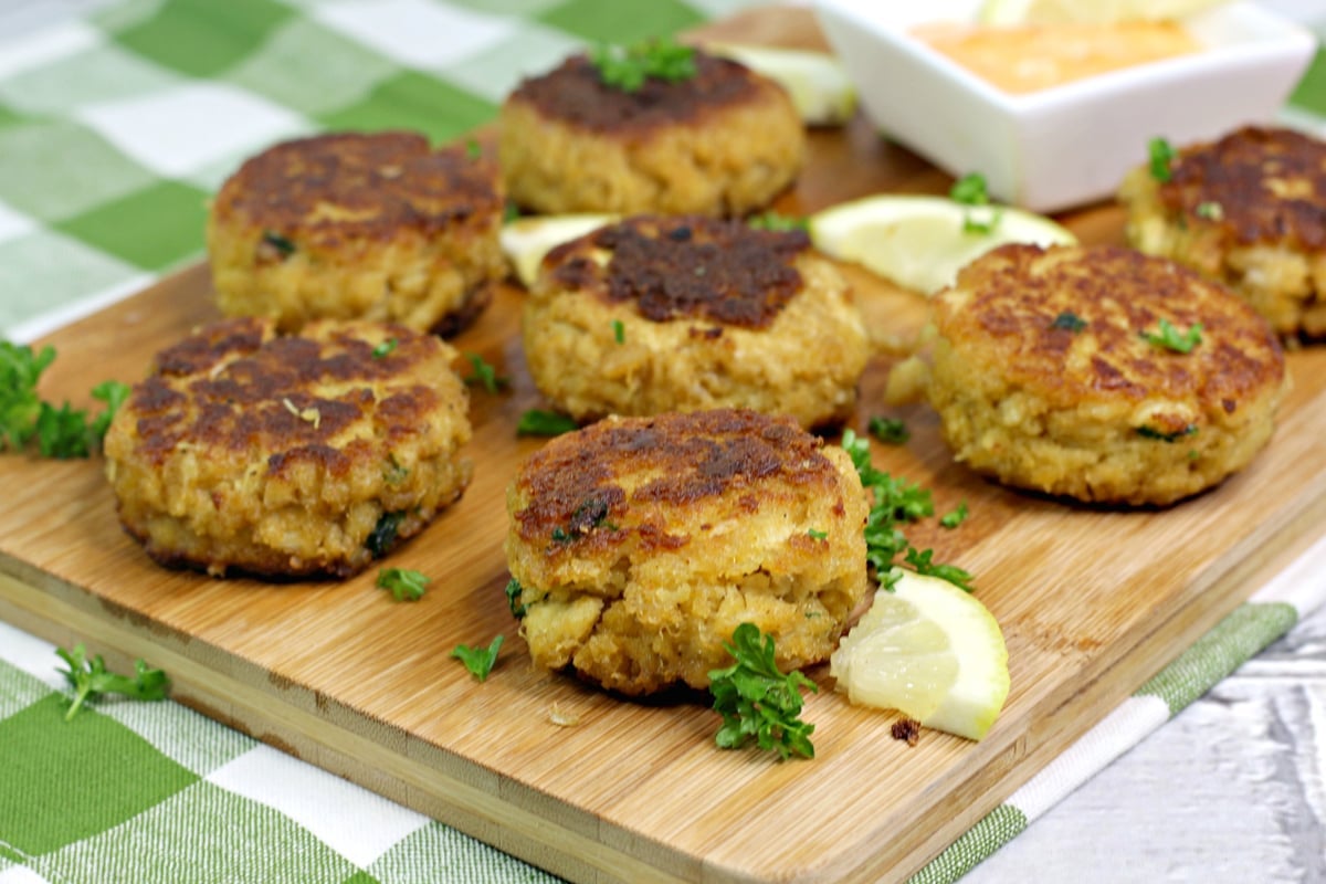 Overhead view of crab cakes on a wooden cutting board