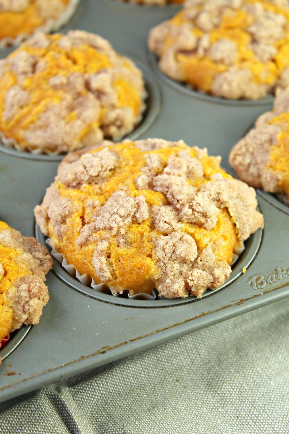 Pumpkin cream cheese muffins in a muffin pan