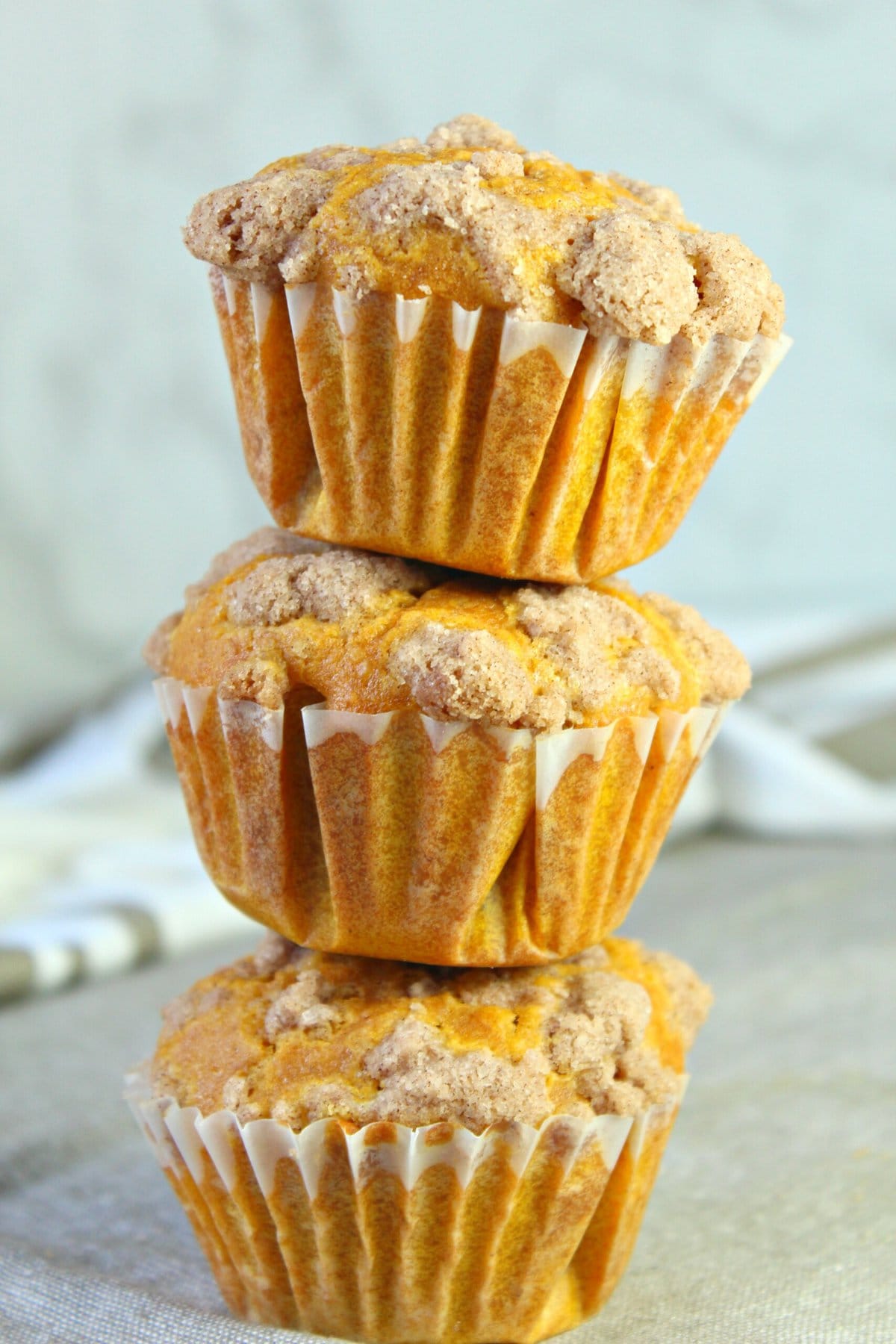 Pumpkin cream cheese muffins stacked on top of each other
