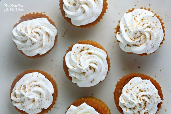 Overhead view of pumpkin cupcakes topped with whipped cream