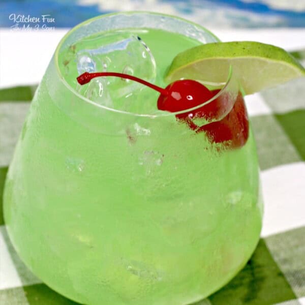 Tipsy Mermaid Cocktail in a glass with a cherry.