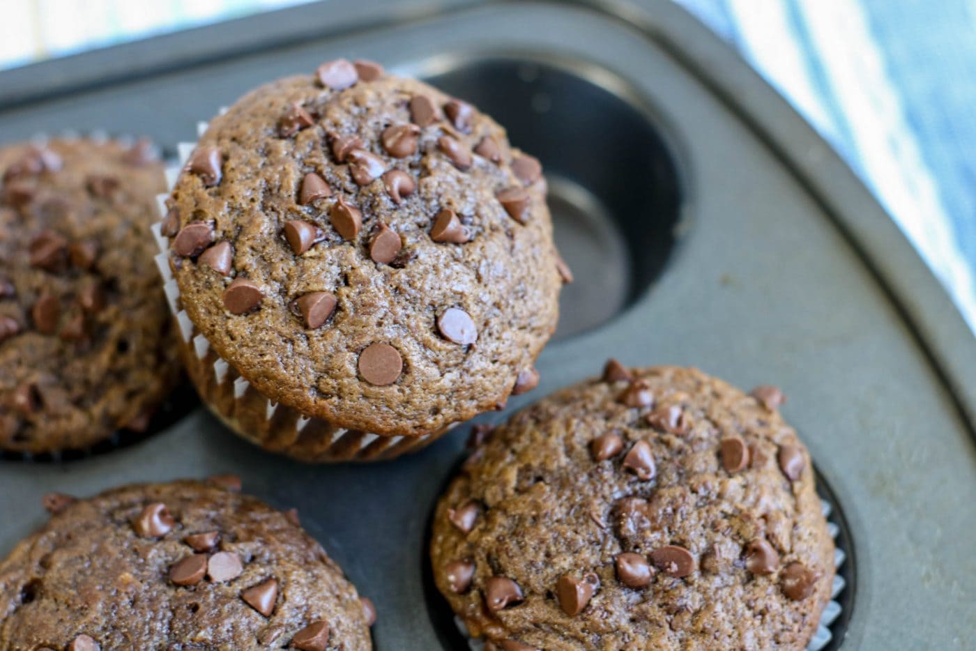 Chocolate Chip Banana Muffins in a muffin pan.