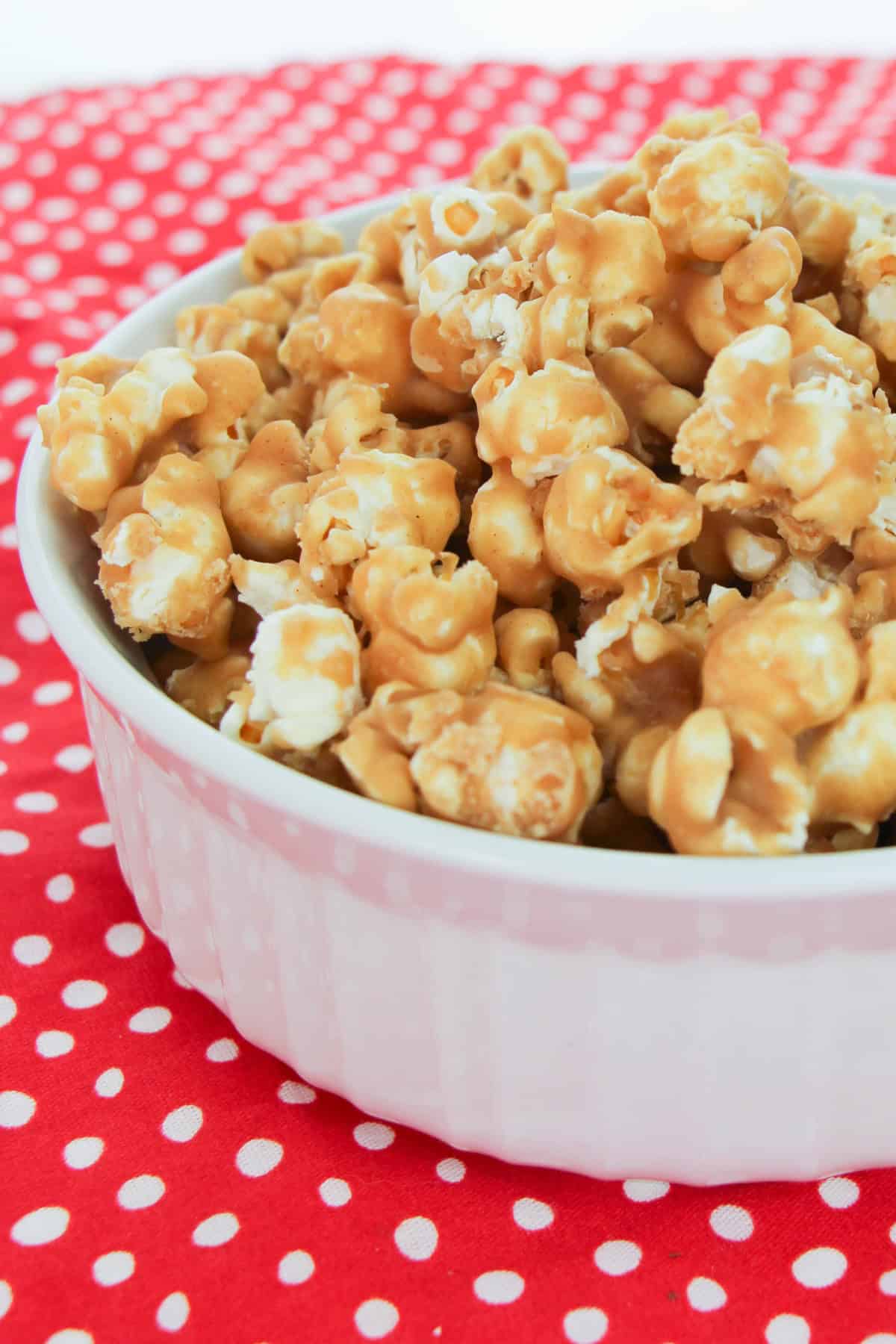 This easy Peanut Butter Popcorn recipe uses just 4-ingredients and is the most delicious snack for peanut butter lovers! Peanut Butter Popcorn in a bowl