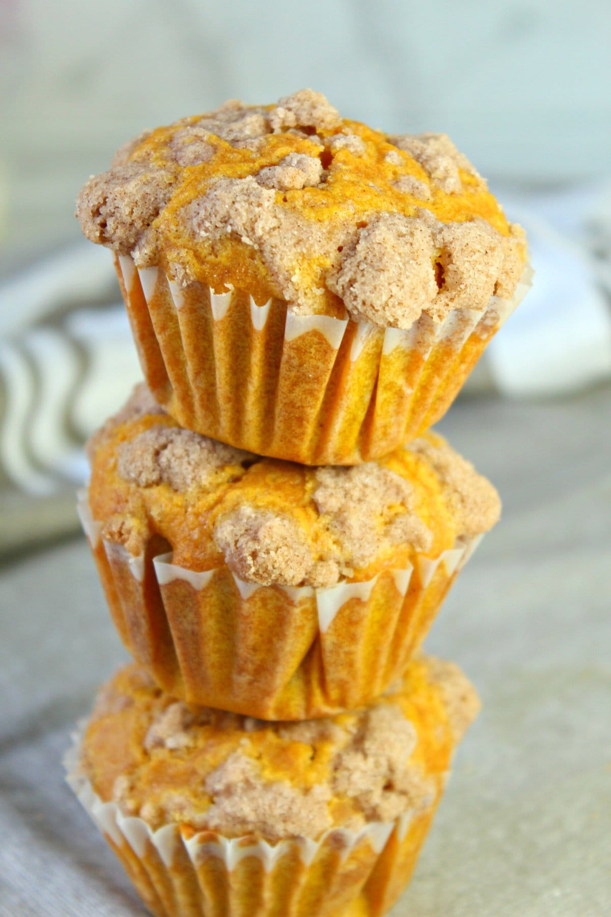 pumpkin cheesecake muffins in a stack