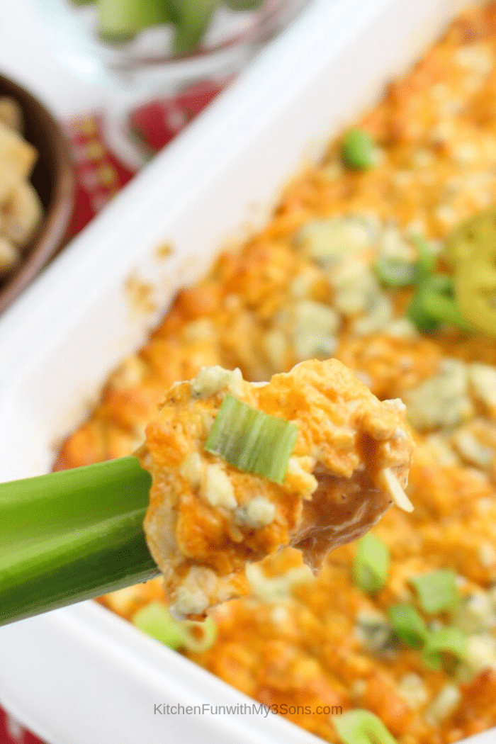 A scoop of easy buffalo chicken dip with blue cheese on a celery stick