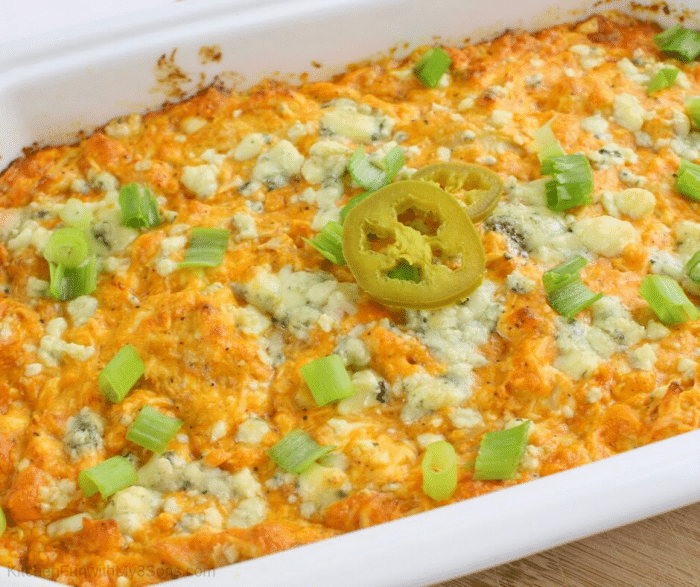 Baked easy buffalo chicken dip in white casserole dish ready to serve