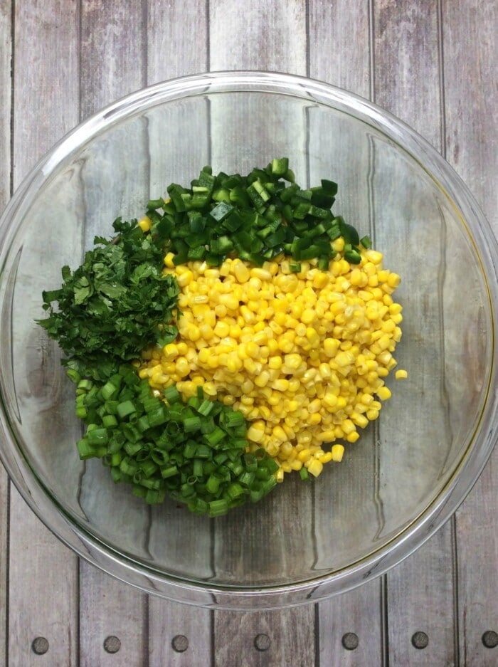 corn, cilantro and green onions in a glass bowl