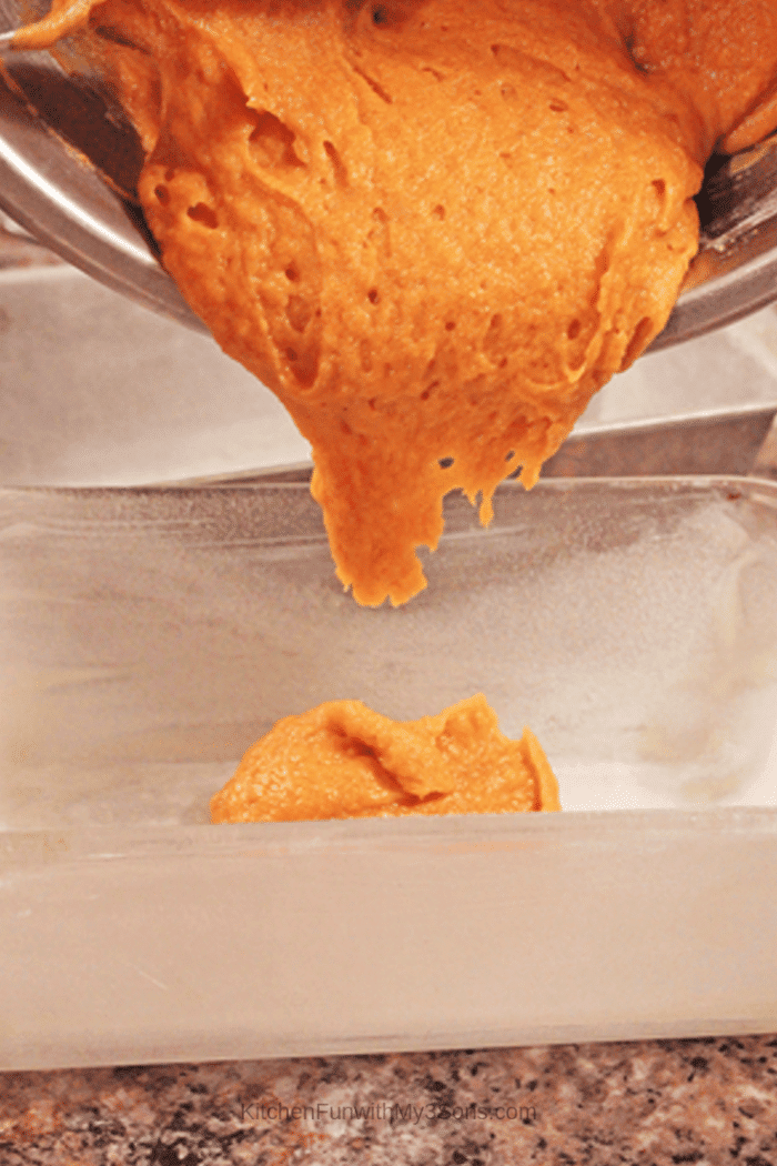 Pouring the batter for gluten free pumpkin bread into a prepared loaf pan