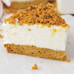 Slice of no bake cheesecake with pumpkin bread crust sitting on a white surface