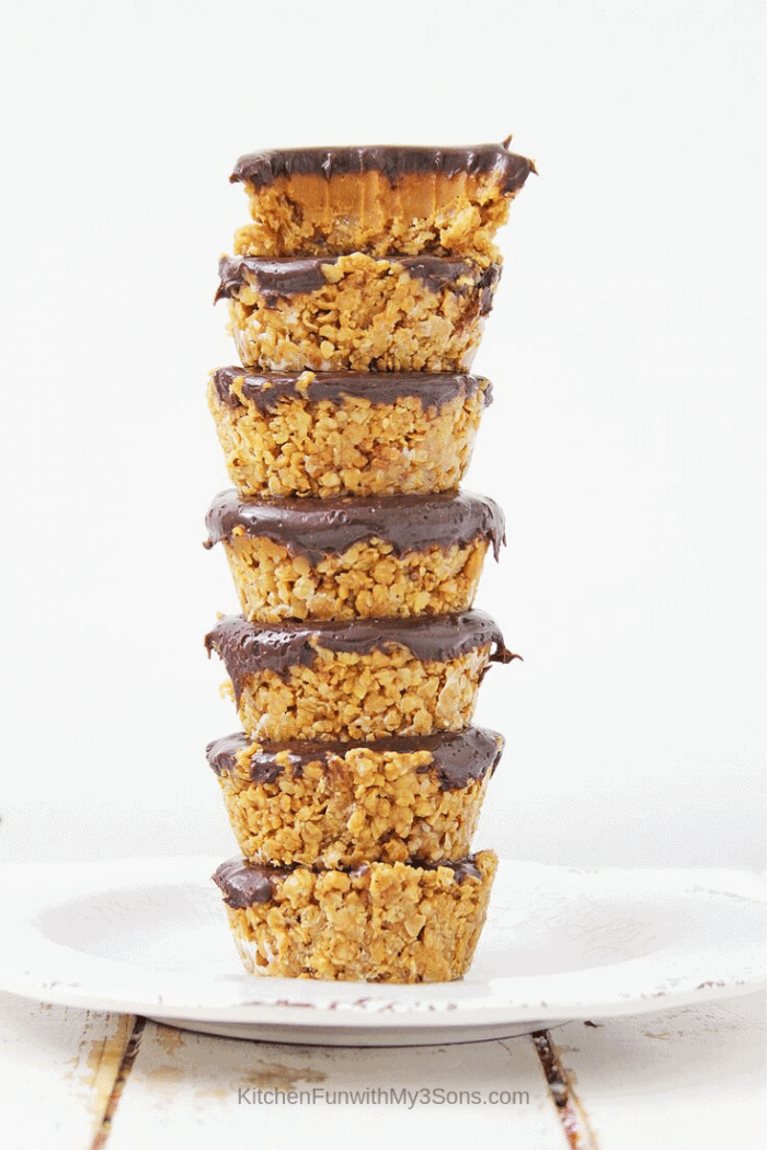 Tall stack of baked oatmeal cups stuffed with peanut butter and chocolate