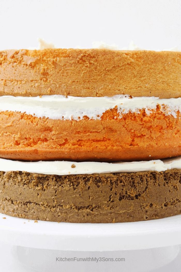 The 3 layers of cake for the pumpkin spice latte cake being prepared on a cake stand