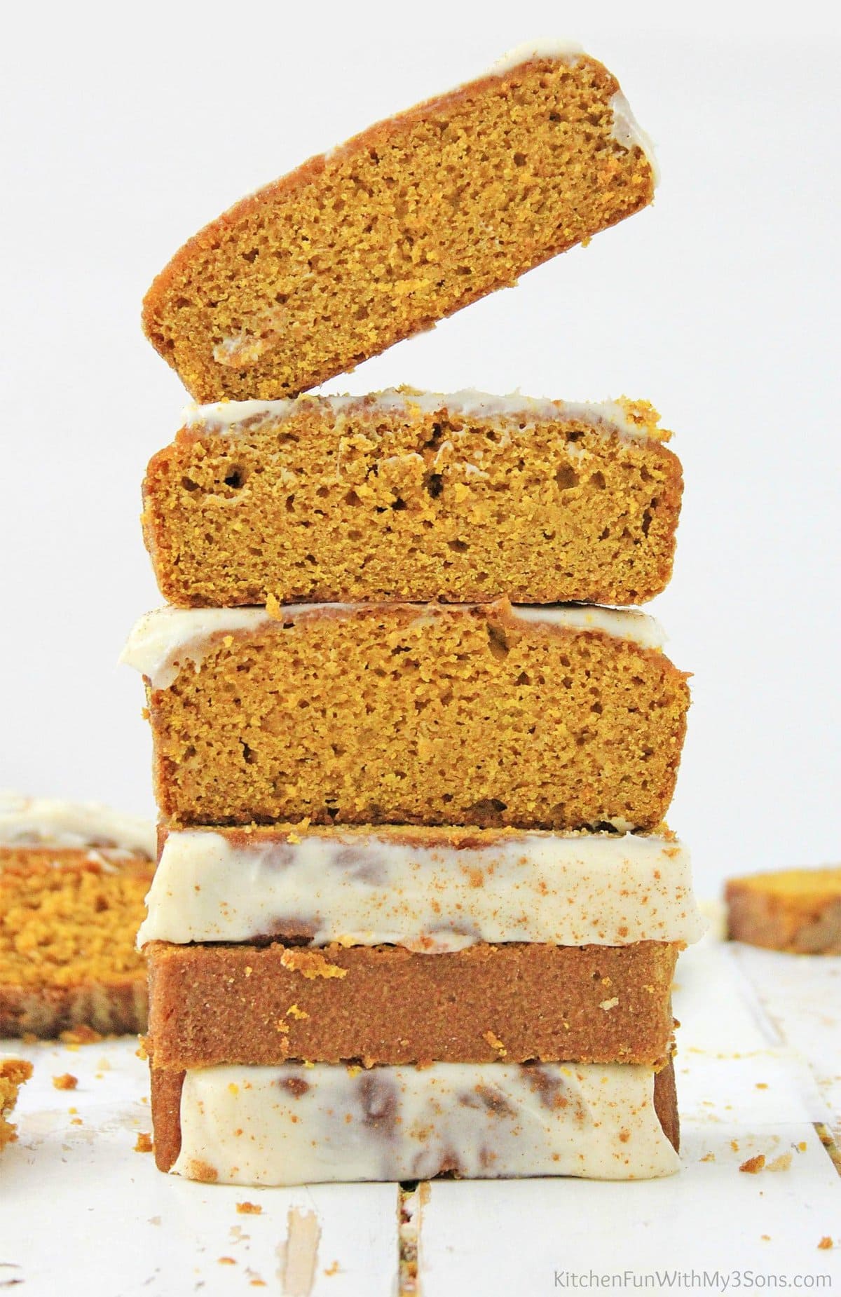 A stack of gluten free pumpkin bread slices sitting on a wood surface