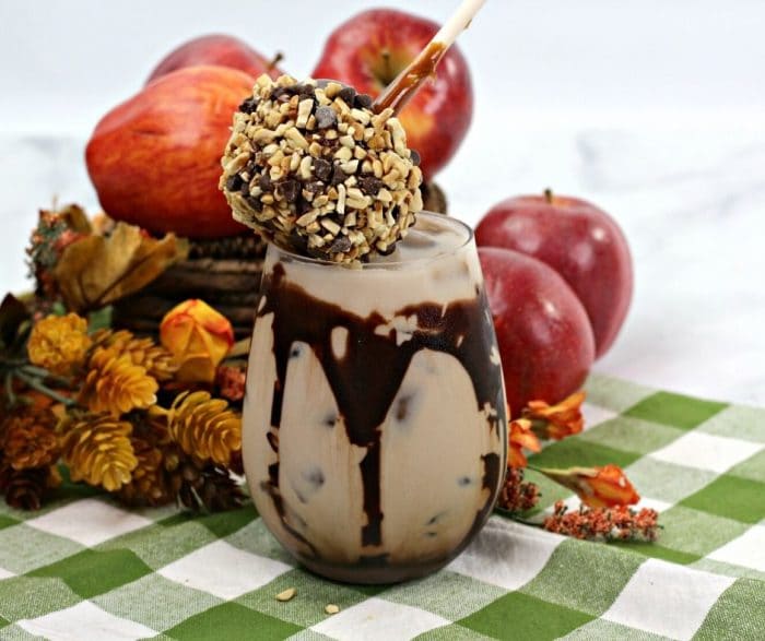 A caramel apple cocktail with chocolate and a caramel apple topping