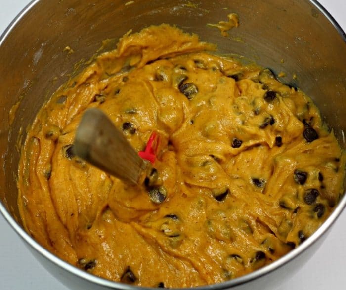 A large mixing bowl filled with batter for chocolate chip pumpkin streusel bread
