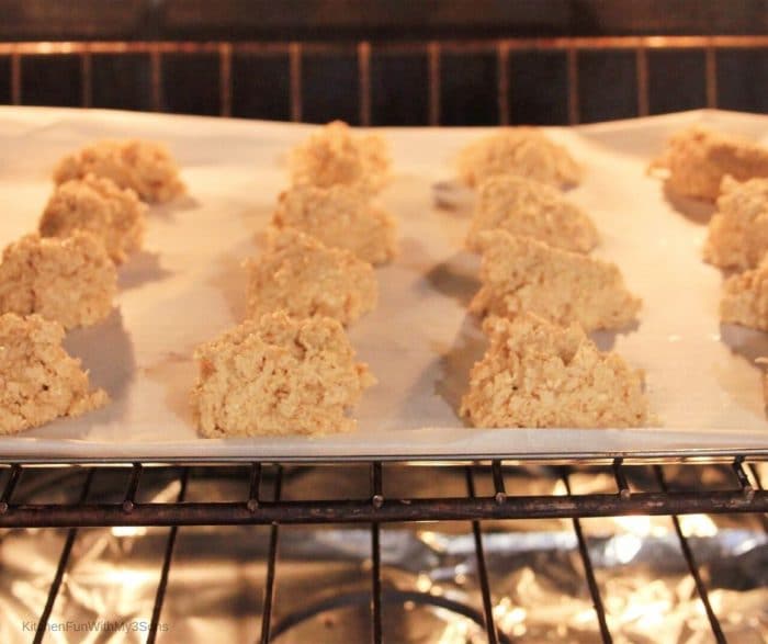 Baking sheet filled with pumpkin spice sugar cookies in an oven
