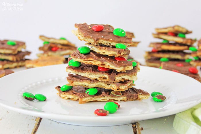 A stack of saltine cracker toffee with holiday M&Ms