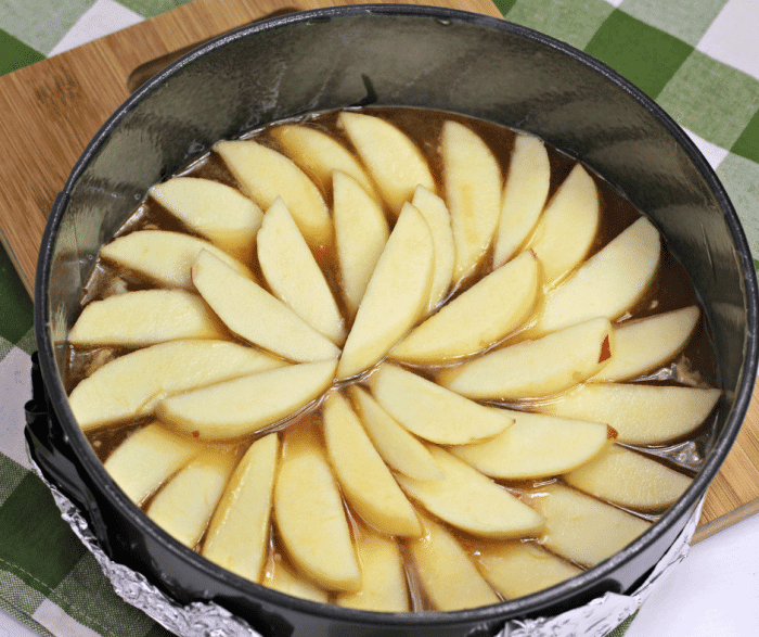 Layering apples and sauce at bottom of pan for apple upside down cake recipe