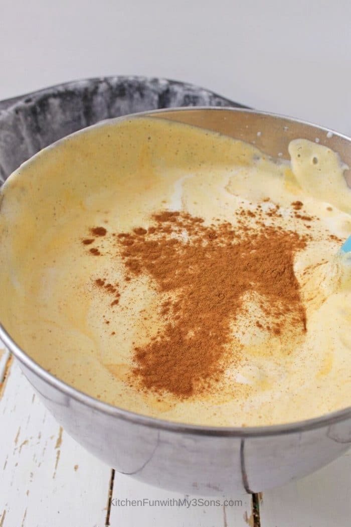 Mixing a bowl of pumpkin angel food cake batter