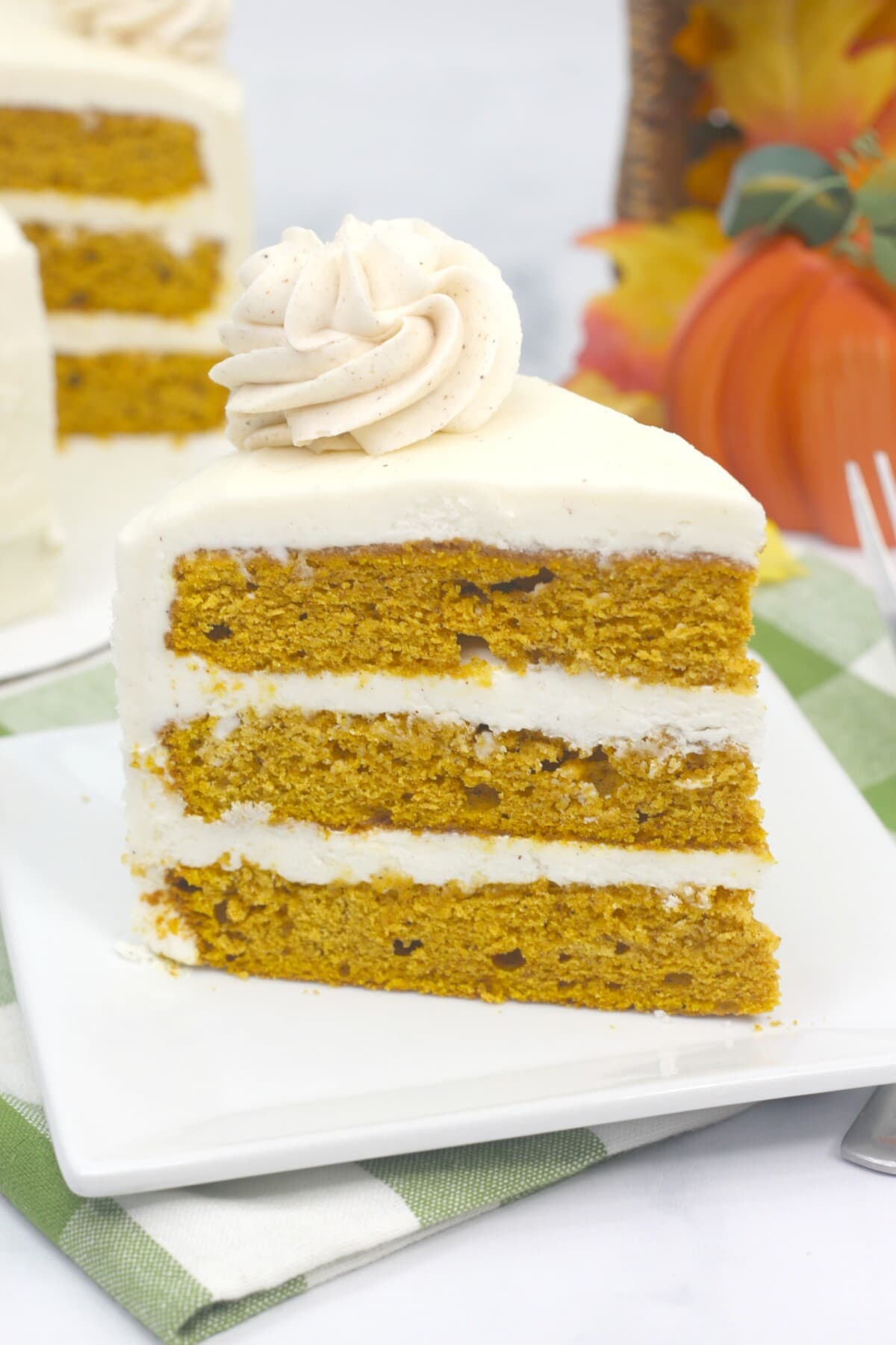Pumpkin layer cake with frosting on top.