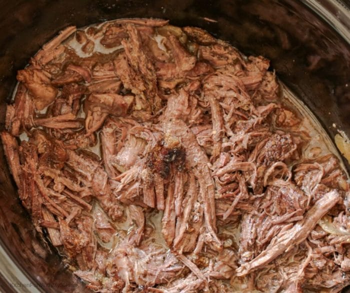 Shredded beef in slow cooker for making french dip sandwiches