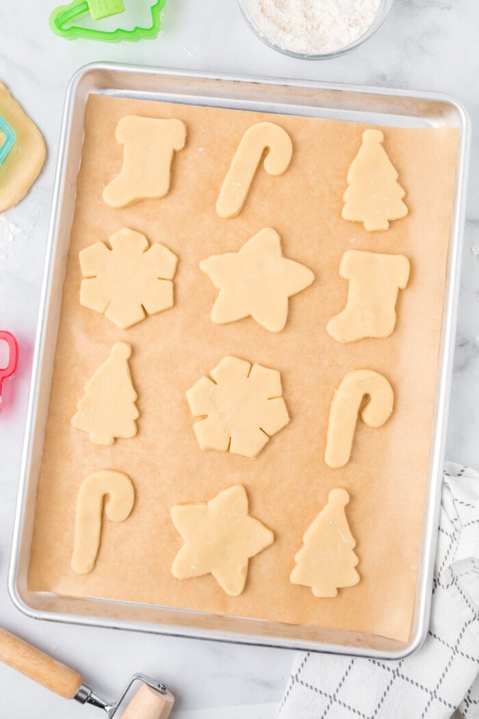 Cut out sugar cookies on a baking sheet