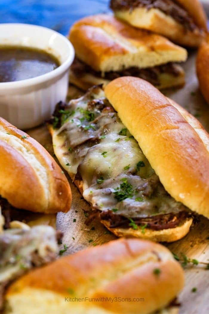 Up close image of a french dip sandwich with melted cheese