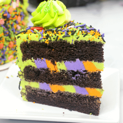 Up close picture of a slice of monster cake on a white saucer