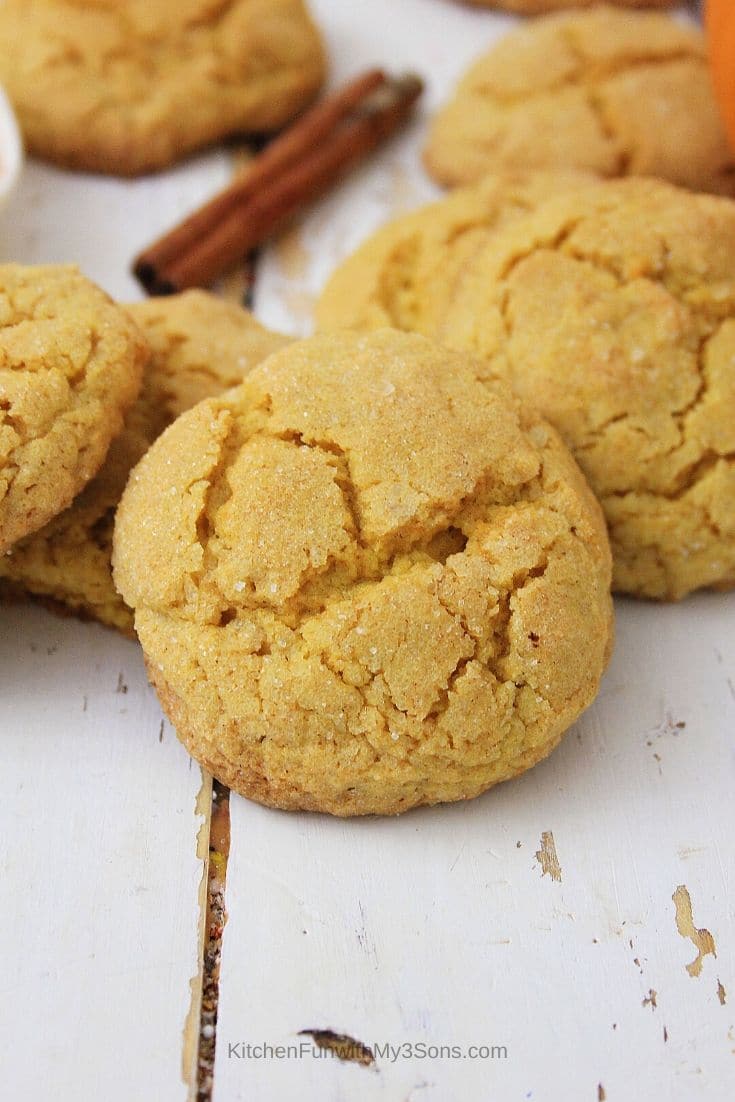 Up close picture of pumpkin sugar cookies on wooden table