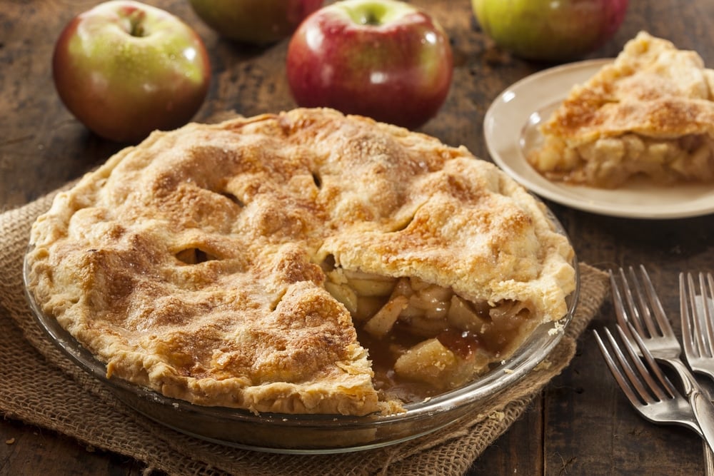 A homemade apple pie with a slice missing