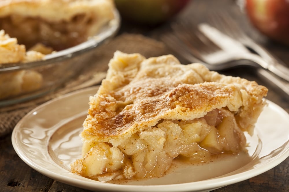 A slice of homemade apple pie on a plate