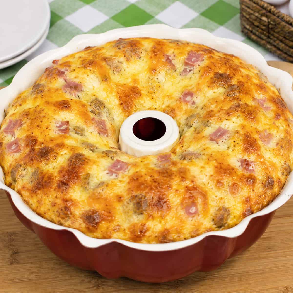 This Breakfast Bundt Cake is a fun twist on a classic breakfast casserole that's loaded with eggs, ham, crispy hash browns, veggies, and plenty of melted cheese. Breakfast casserole in a bundt cake pan