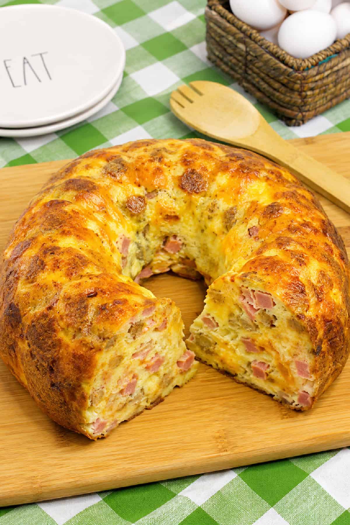 This Breakfast Bundt Cake is a fun twist on a classic breakfast casserole that's loaded with eggs, ham, crispy hash browns, veggies, and plenty of melted cheese. Breakfast Bundt Cake with slices taken out