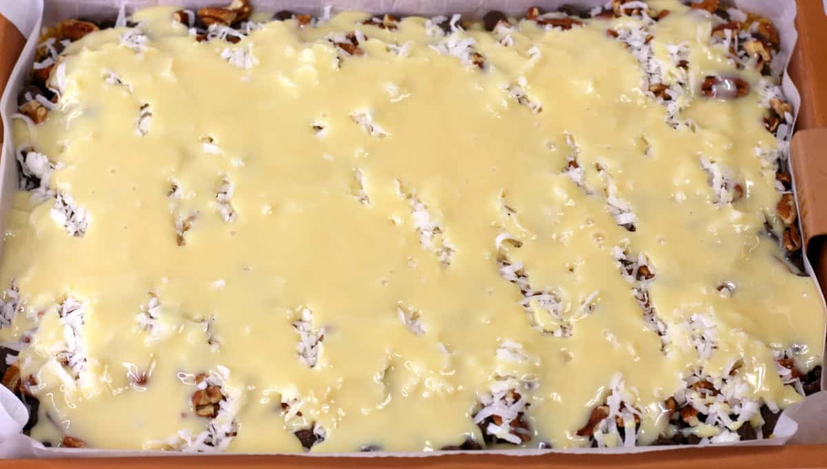 These Hello Dolly Bars are loaded with chocolate chips, coconut, and crunchy pecans over a buttery graham cracker crust.