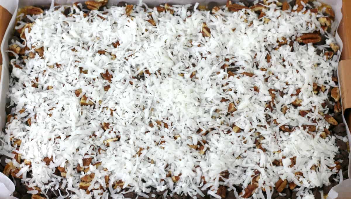 These Hello Dolly Bars are loaded with chocolate chips, coconut, and crunchy pecans over a buttery graham cracker crust.
