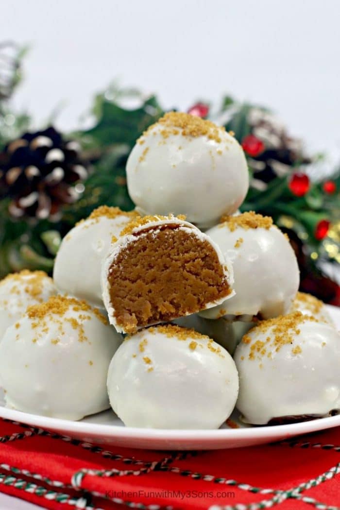 A stack of gingerbread truffles on a white plate sitting on a red holiday napkin