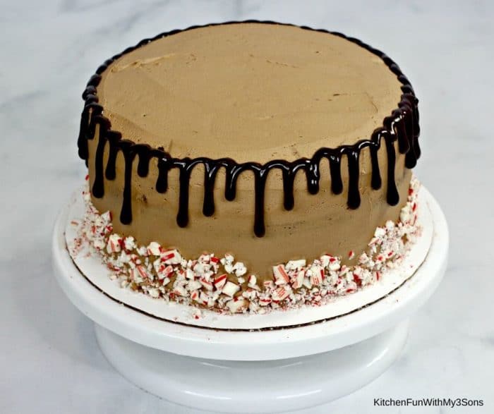 Adding chocolate ganache drizzle to the cake