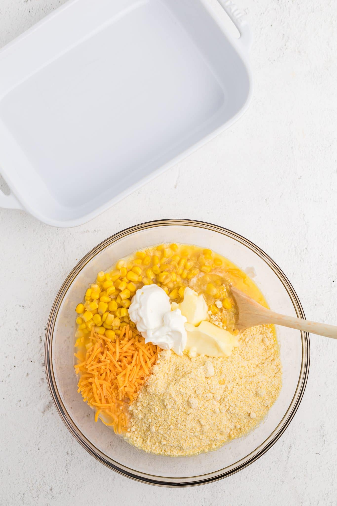 Corn casserole ingredients in a mixing bowl