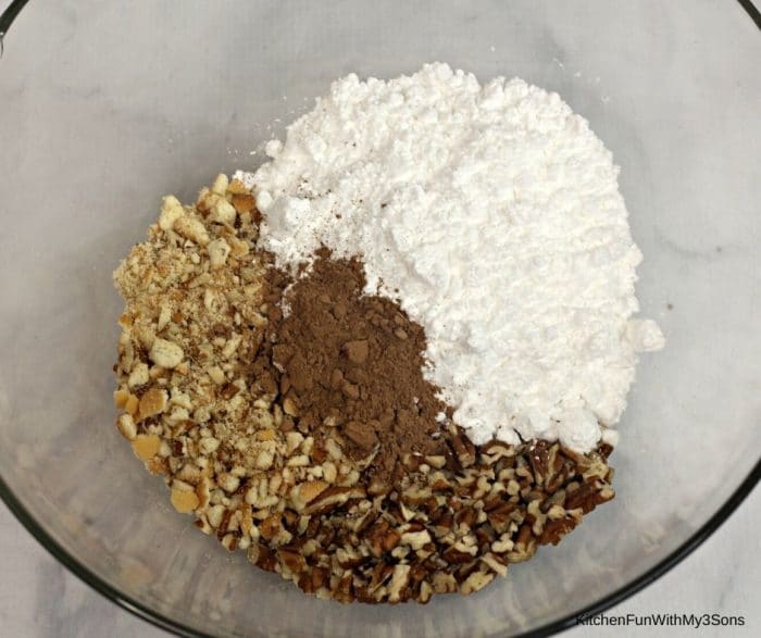 Dry ingredients for whiskey Holiday Cookie balls in a large glass bowl