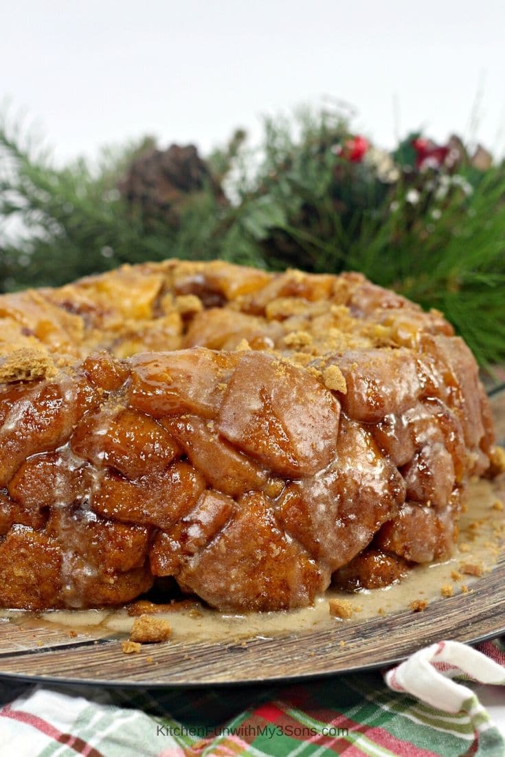 Gingerbread monkey bread on a wooden tray with greenery in the background