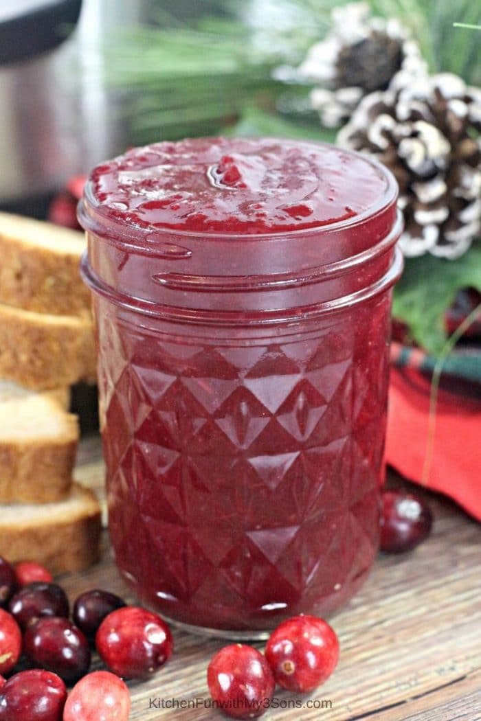 Instant Pot Cranberry Butter in a mason jar next to holiday decorations