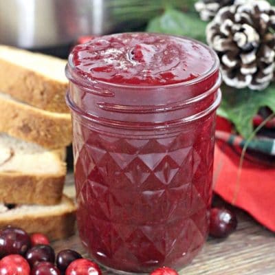 Instant Pot Cranberry Butter in a mason jar next to sliced bread