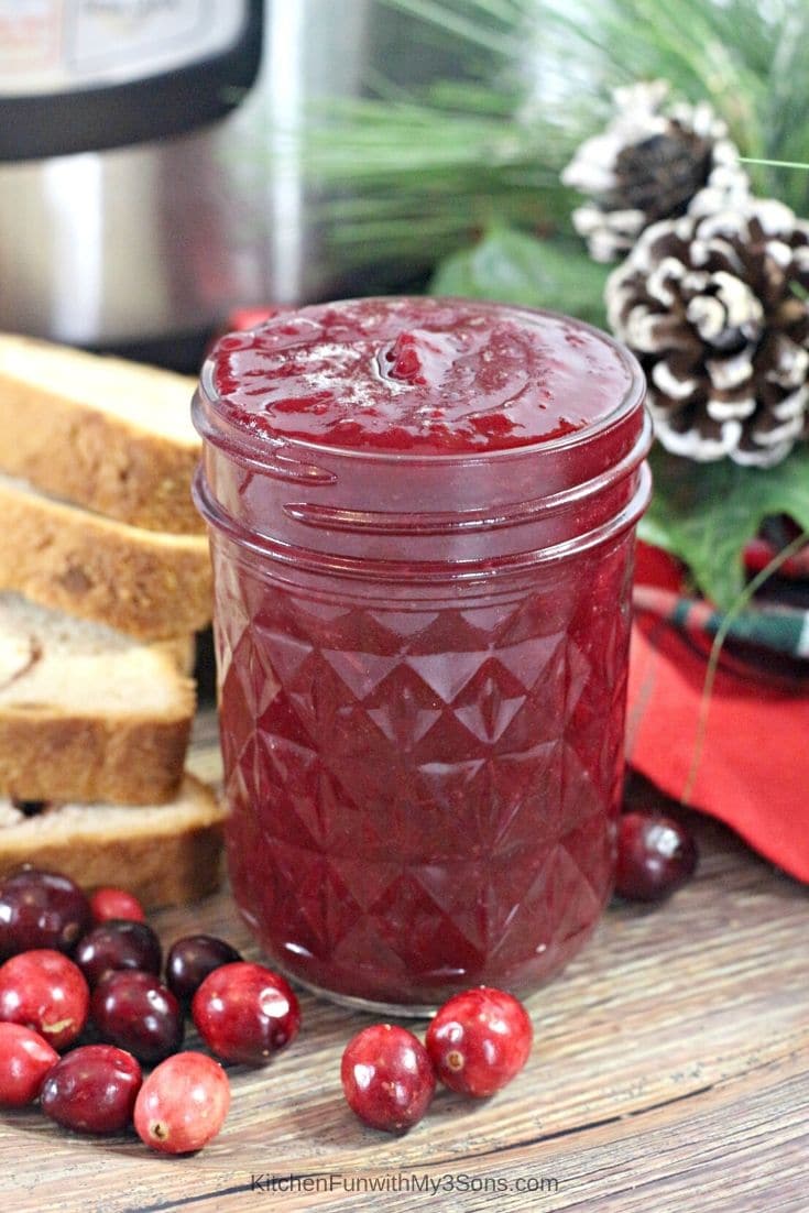 Instant Pot Cranberry Butter in a mason jar next to sliced bread
