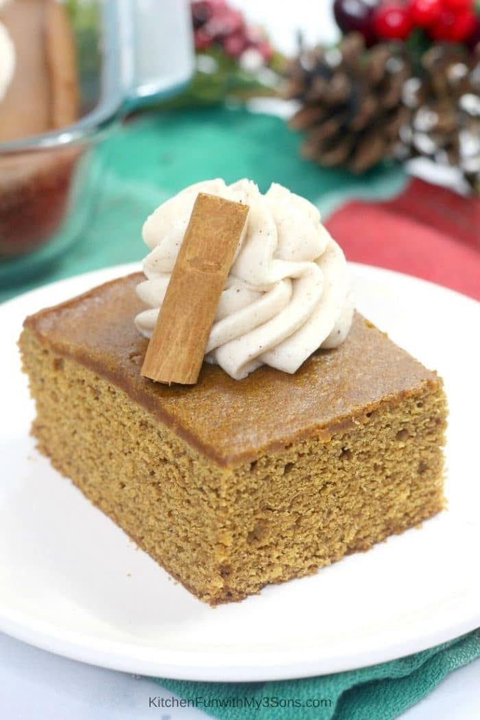 Old fashioned gingerbread cake on a white plate with cinnamon frosting