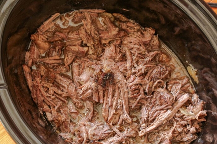 Shredded beef and au jus in a slow cooker