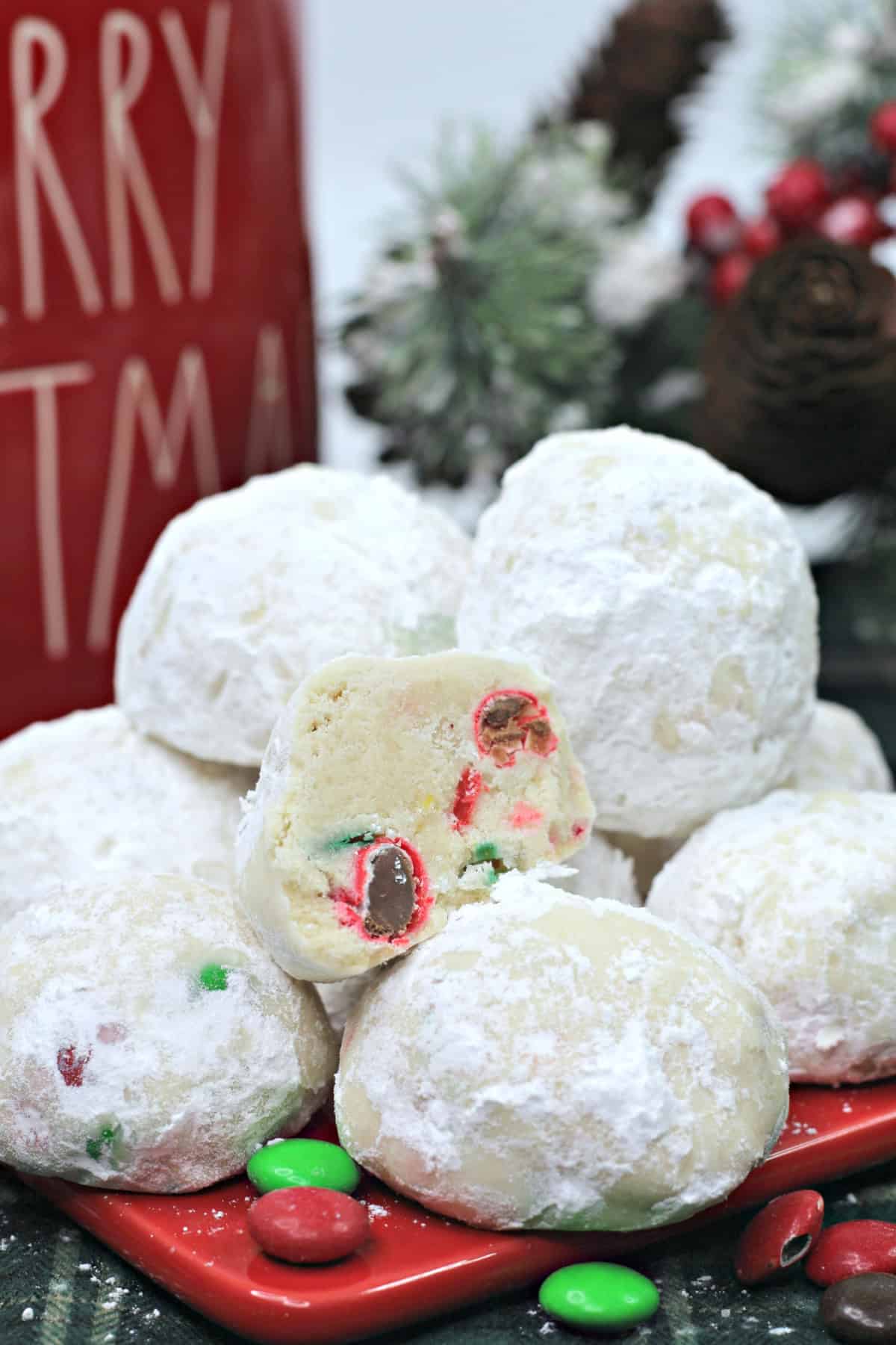 A plate of snowball cookies with M&Ms