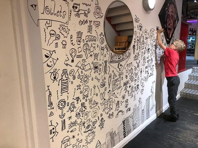 Kid Told Not to Doodle in Class Gets Hired by Local Restaurant to Decorate Their Walls