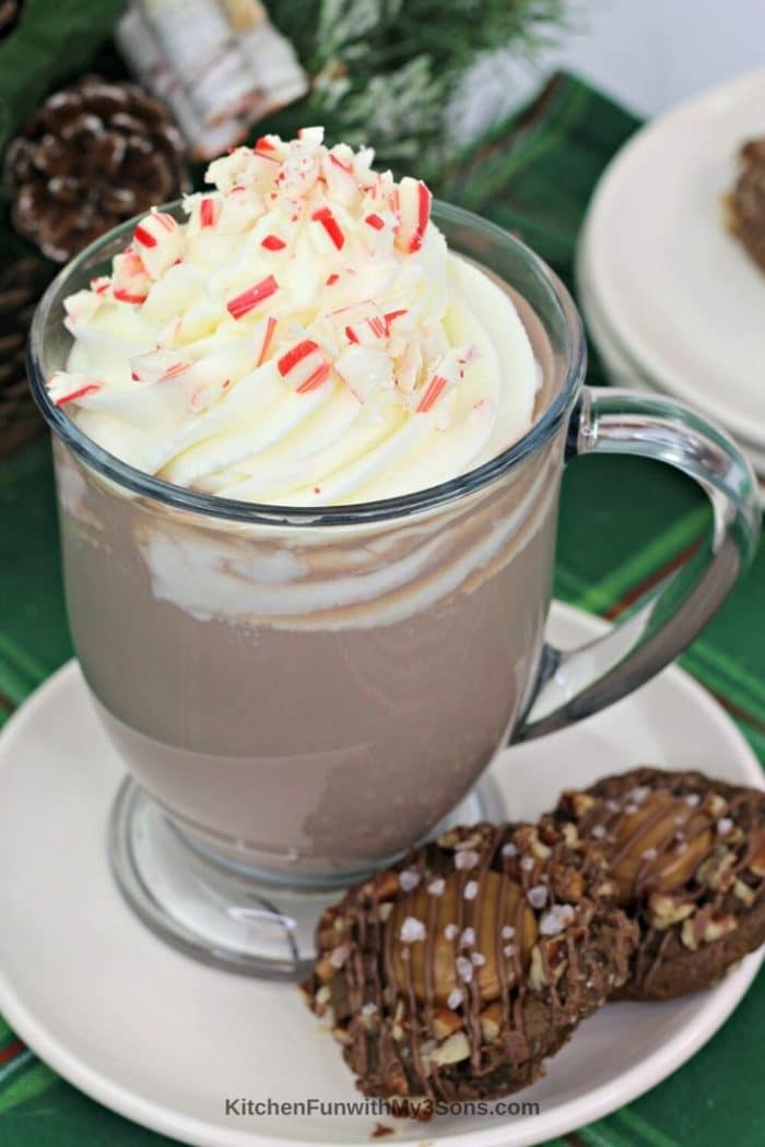 Boozy Peppermint Mocha in a mug on a table with cookies