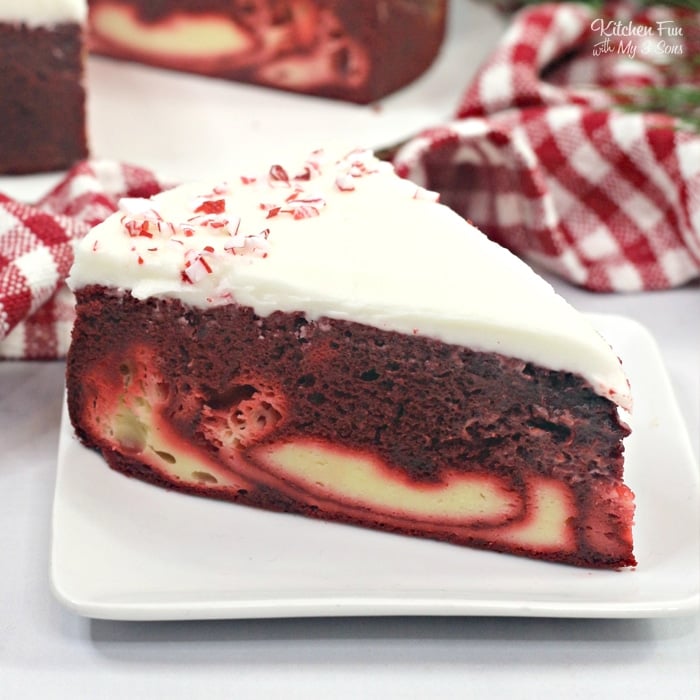 Candy Cane Cheesecake Cake is a fun holiday dessert recipe with a layer of moist Red Velvet cake, a layer of cheesecake and topped with a homemade cream cheese frosting.