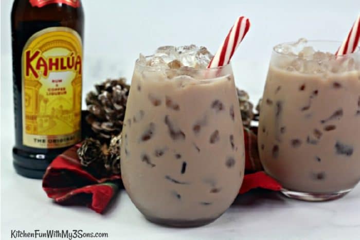 Chocolate White Russian in short glasses with a bottle of Kahlua in background