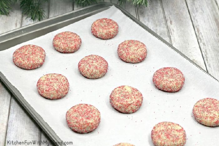 Christmas sugar cookies with sprinkles on baking sheet